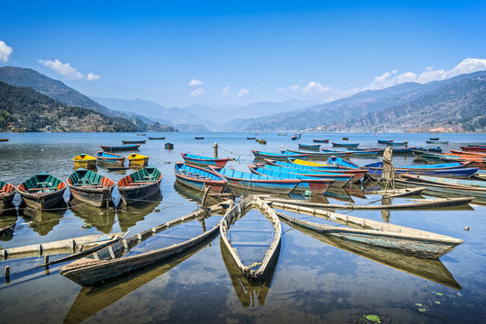 Colorful boats on Phewa lake, Pokhara, Nepal. Wide angle landscape