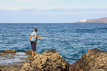 Fototapeta na wymiar Fisherman watching the sea in Agaete, Gran Canaria