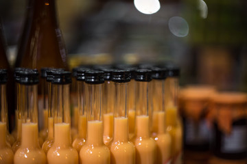 many bottles on the counter in the store