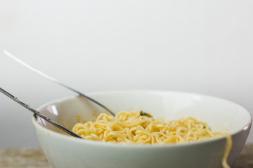 Instant noodles in wooden bowl on wood background front view