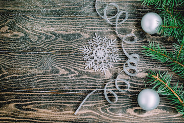 Christmas New Year's composition Christmas balls snowflake ribbon on a wooden background with snow imitation