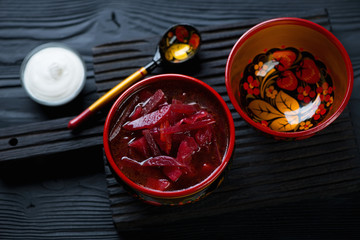 Russian traditional borscht served in wooden khokhloma tableware