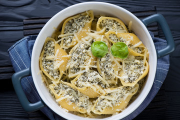 Casserole with cottage cheese and spinach stuffed conchiglioni