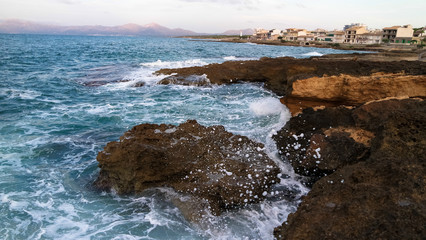 Rock with crashing waves