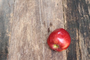 red apple on wooden background, top view with copy space.