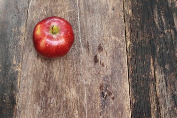 red apple on wooden background, top view with copy space.