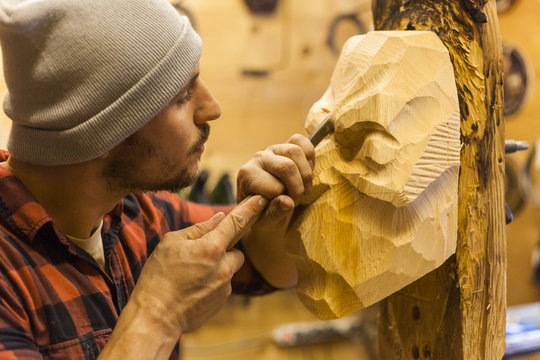 Wood carver manufacturing traditional Krampus mask