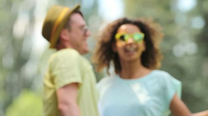 Young couple swaying from side to side in warm embrace, smiling at each other - Powered by Adobe