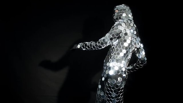 person dancing in amazing discoball mirror suit