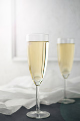 Glasses with New Year champagne on marble table.