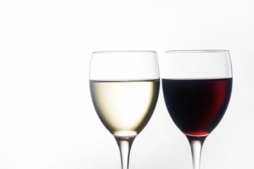 Weißwein und Rotwein im Glas vor hellem Hintergrund