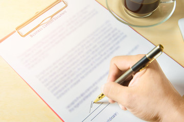 Businessman is signing a contract, business contract details