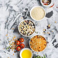 Lentils, bulgur, wheat cereal, dried tomatoes and onion with olive oil on a marble background. Ingredients for dinner. Top view. Ready-mix  soup