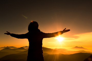 Fototapeta premium Woman on top of mountain. Trip concept.
