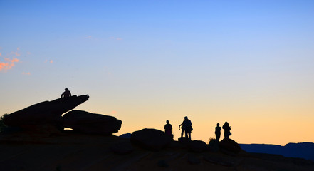 Silhouette of tourists waiting for sunset at Horseshoe Bend, Arizona Desert