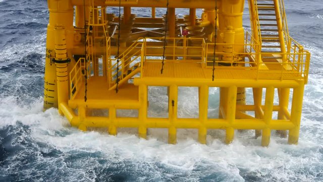 High Waves Hit Oil and Gas Producing Slots and Platform Legs at Offshore Platform - Oil and Gas Industry
