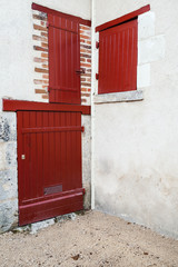 Corner of an old European house, red doors
