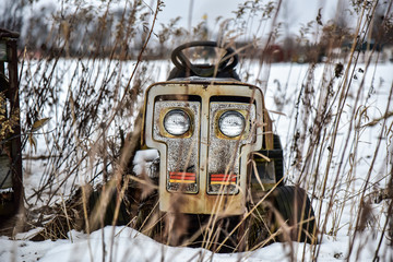 Abandoned tractor in winter field 
