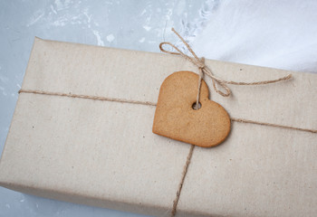 Gift boxes are packed in kraft paper with cookies - heart on Valentine's Day.