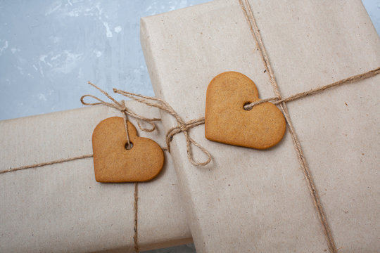 Gift boxes are packed in kraft paper with cookies - heart on Valentine's Day.