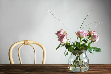 Glass vase with bouquet of beautiful flowers on table