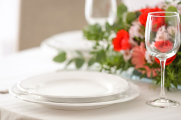 Elegant table setting with beautiful flowers, closeup