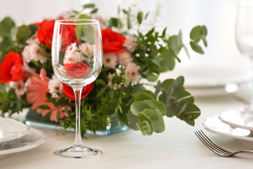 Elegant table setting with beautiful flowers, closeup