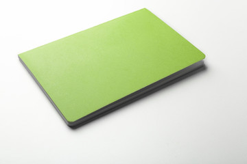 Blank green notebook on white background