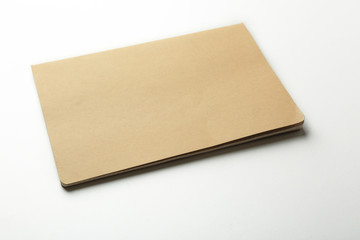 Blank beige notebook on white background
