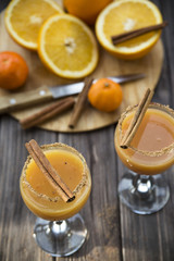 alcoholic beverage with orange juice and cinnamon