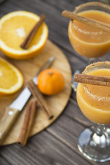 alcoholic beverage with orange juice and cinnamon
