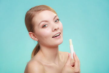 woman applying balsam for lips