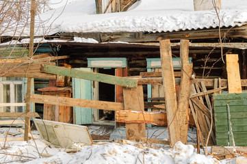 Wooden abandoned old house with the driven-in windows in Tyumen. Russia