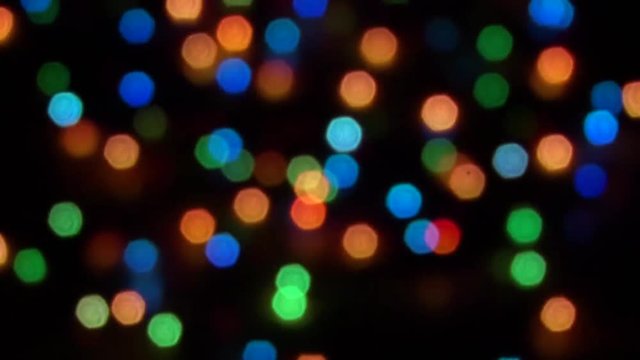 Blurry abstract colorful background. Colored Christmas garland. Bokeh and defocusing of the lens