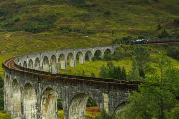 UK, Scotland, Highlands, Jacobite Steam Train crossing the Glenfinnan Viaduct.