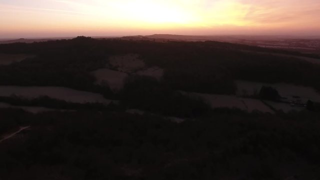 Rising aerial shot of the Clent Hills before dawn, Worcestershire, UK.