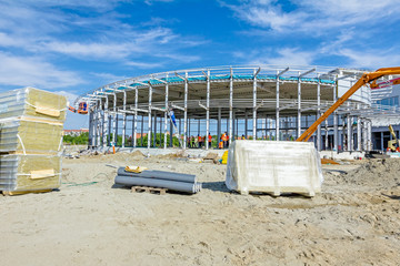 Stack of insulation composite panel walls are piled on building