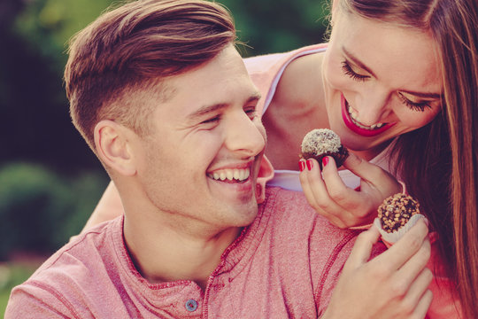 Smiling Couple Feeding Each Other.