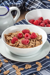 Tasty breakfast with milk and raspberries.