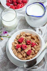 Tasty breakfast with milk and raspberries.