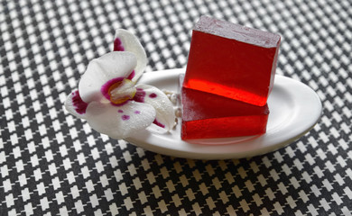 Natural soap and orchid flower are on the dish.