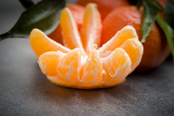 Ripe orange tangerine clove on the gray table