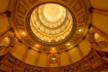 Obraz premium Interior of Gold Dome of Colorado State Capitol Building - A low-angle view of interior Gold Dome, and its stair cases with holiday decorations, in Colorado State Capitol Building, Denver, Colorado.
