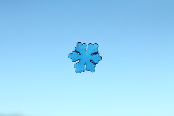 Tiny jelly snowflake on a blue background