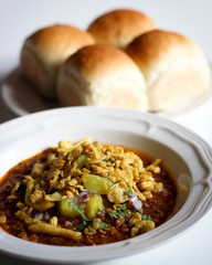 Misal Pav - Indian Spicy Breakfast Dish, Mumbai Street Food (Soft Bread served with spicy tangy curry with sprouts and fried crispy toppings)
