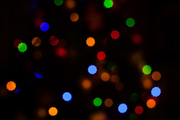 Obraz premium Christmas Background with defocused lights of a fir tree