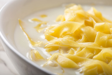 Close up of noodles (tagliatelle) with milk and sugar