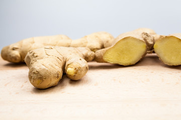 Ginger pieces on wooden kitchen board