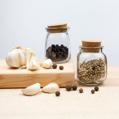 Garlic and spices on wooden kitchen board