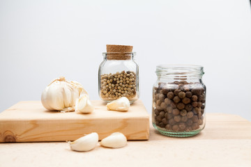 Garlic and spices on wooden kitchen board